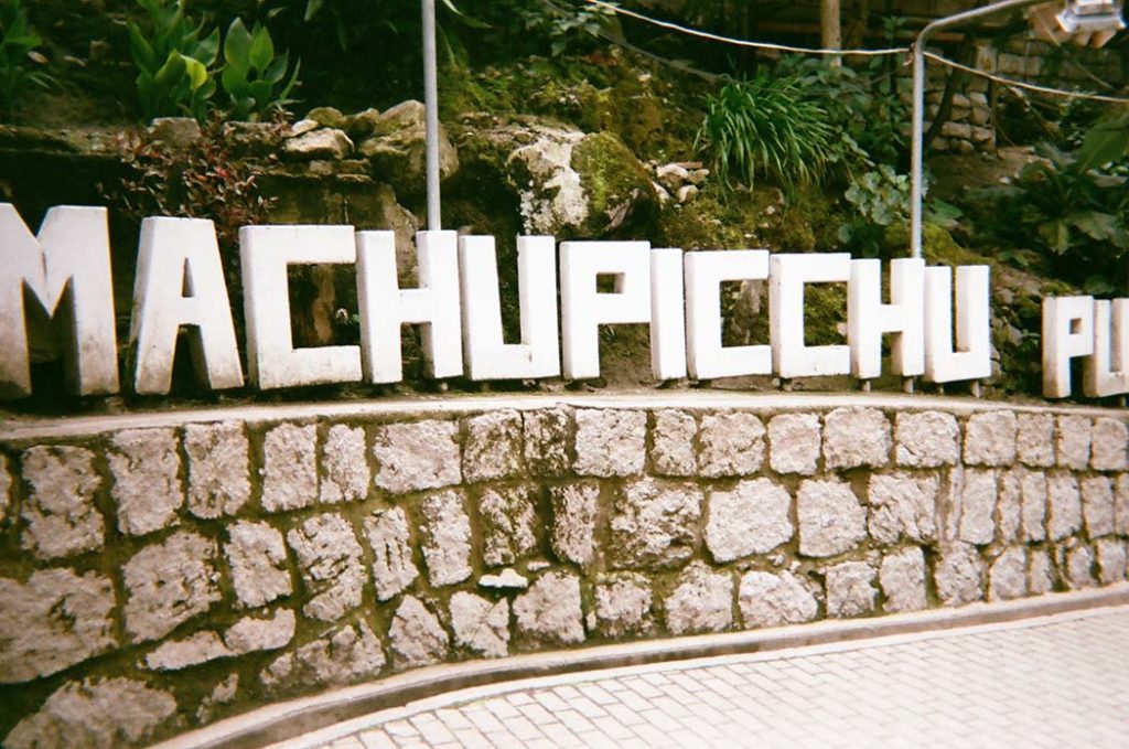 Machu Picchu Sign in Aguas Calientes or Machu Picchu Town - traveling sick in Machu Picchu