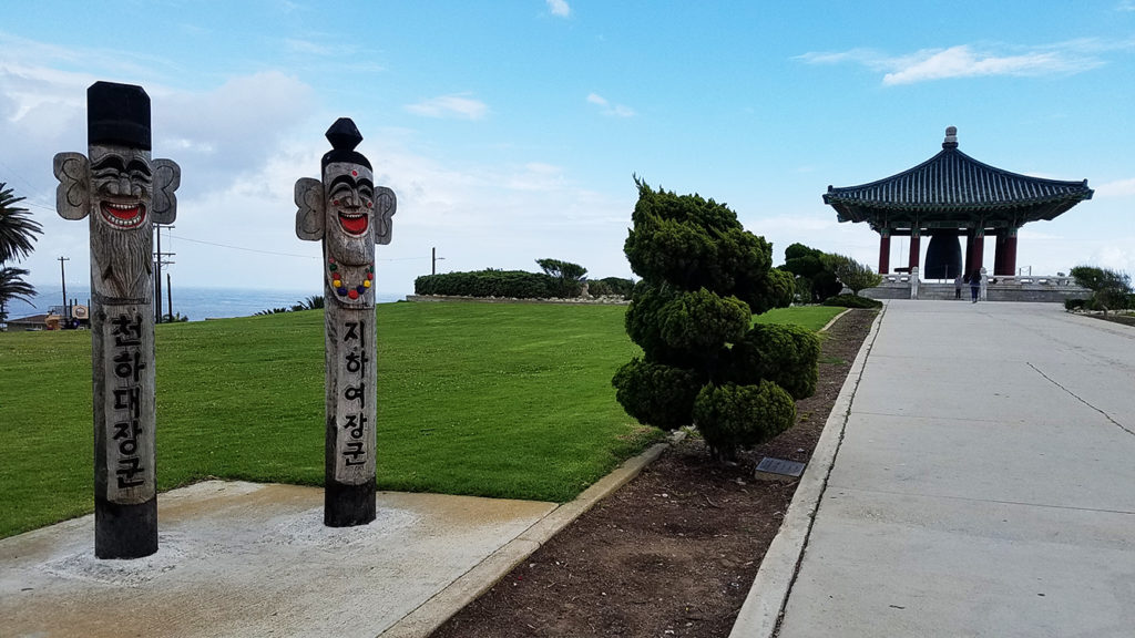 Korean totem poles called jangseung at the entrance to the Korean Friendship Bell