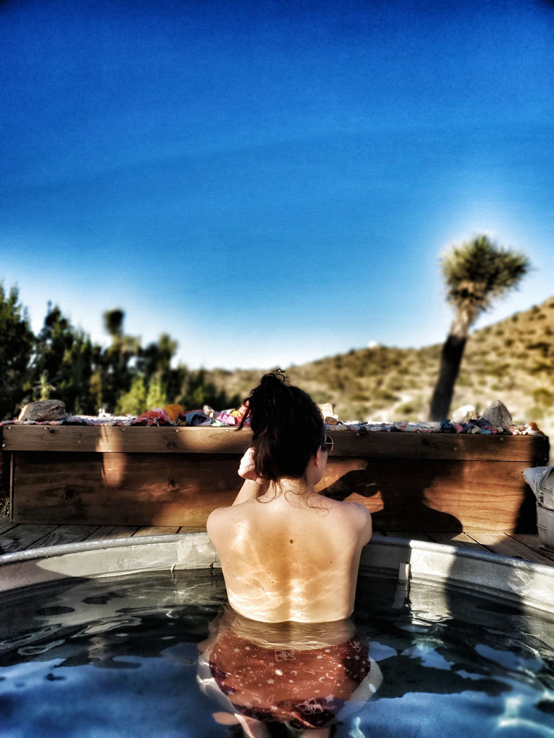 Soaking in the hot tub of The Deserted Joshua Tree Cabin Dreams are made of