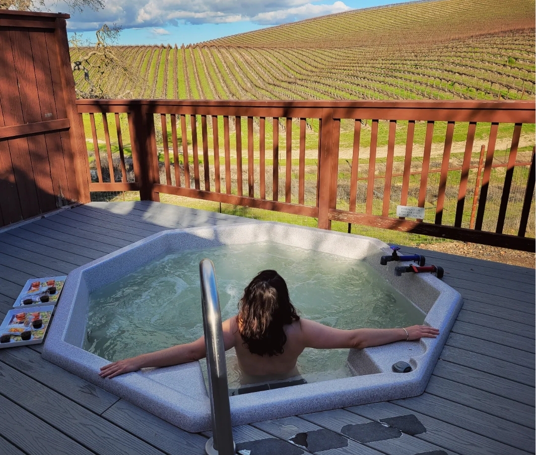 Linds soaking in the mineral tub in a vineyard, wine tasting on a socal to central coast and back getaway