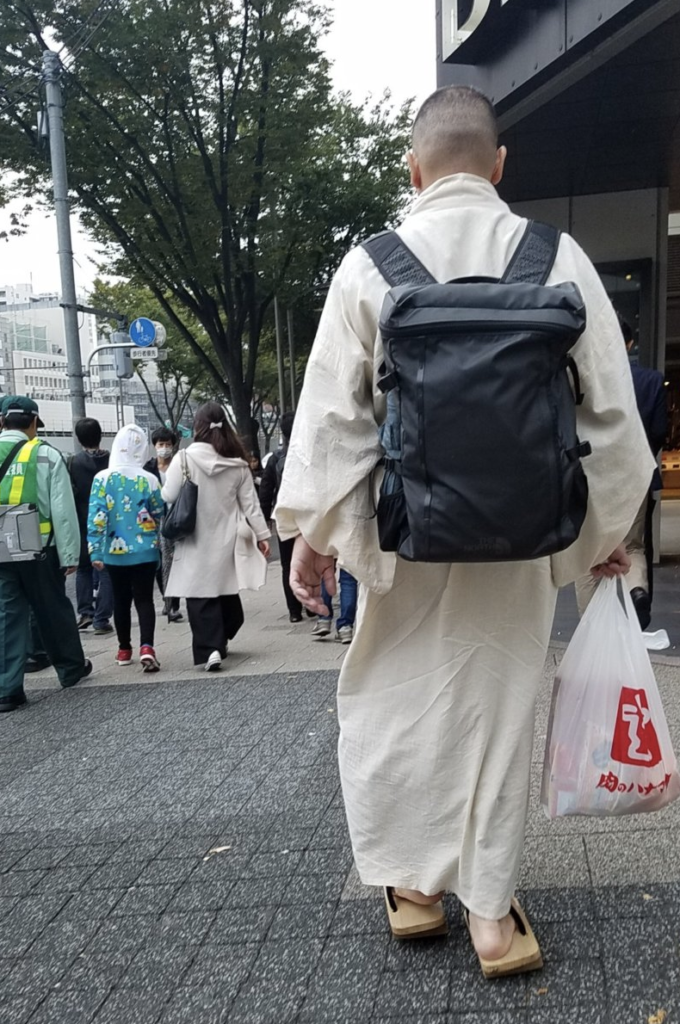 Man in Japan with backpack on traveling lightly