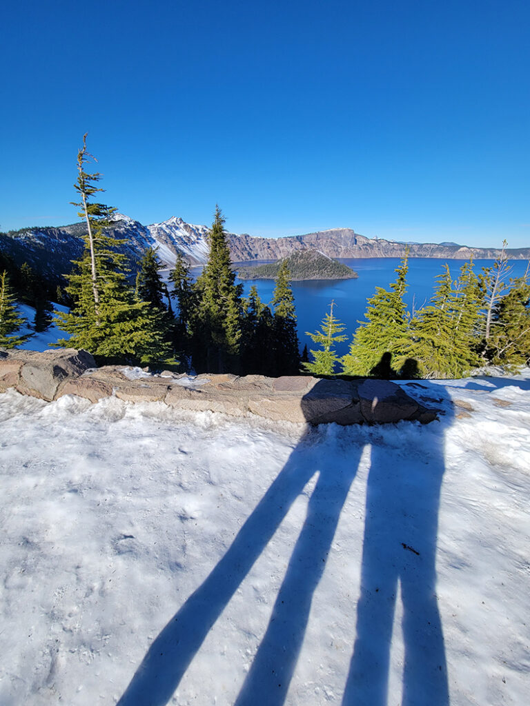 Shadows in the snow overlooking Crater Lake - beautiful blue skies