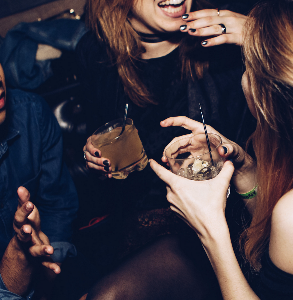 women during a night out, drinking and laughing