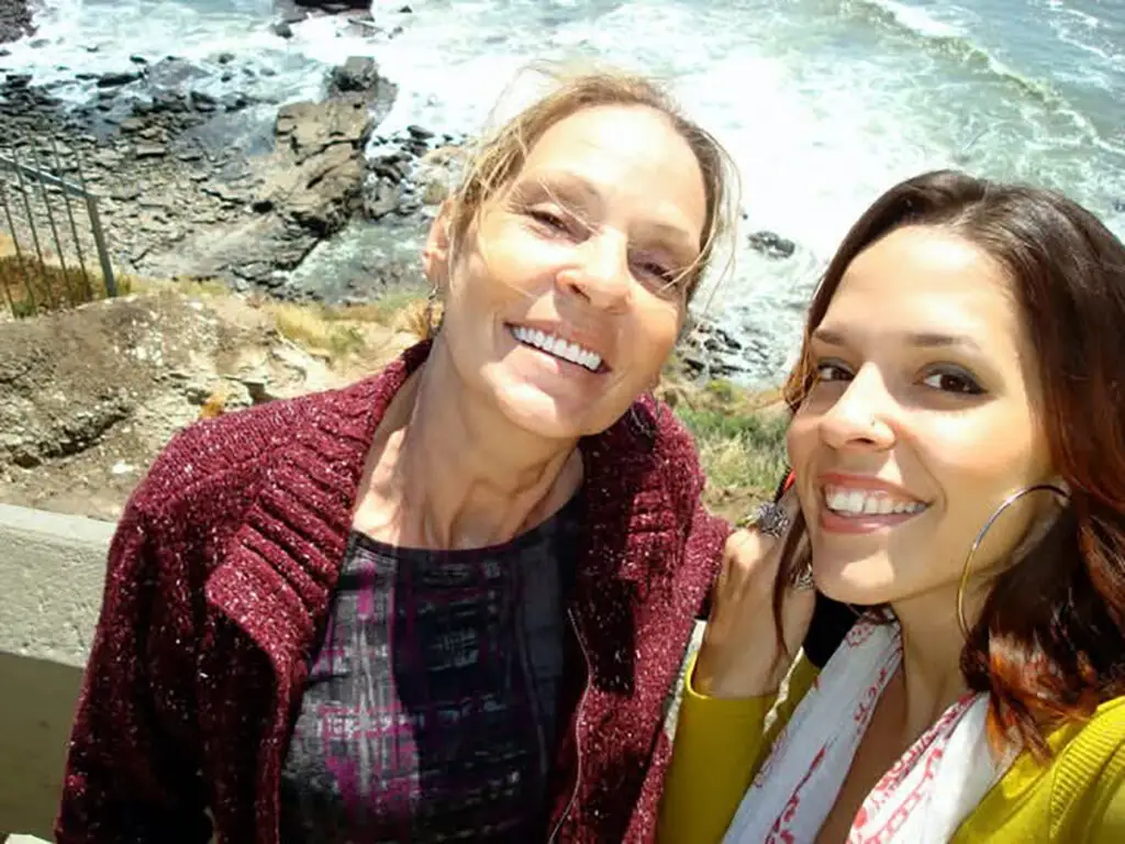 Lindsay Taylor Dellinger and her mama smiling with ocean shore in background