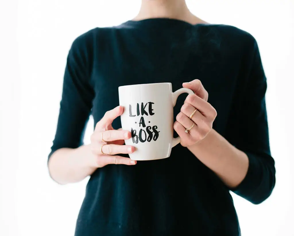 Like a Boss written on a mug held by a woman wearing black