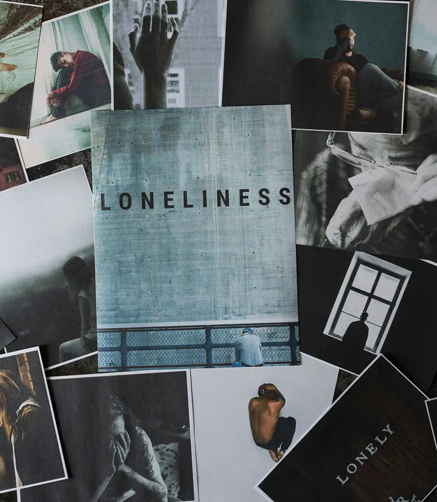 Loneliness spelled out on wall with polaroids of lonely-looking men surrounding