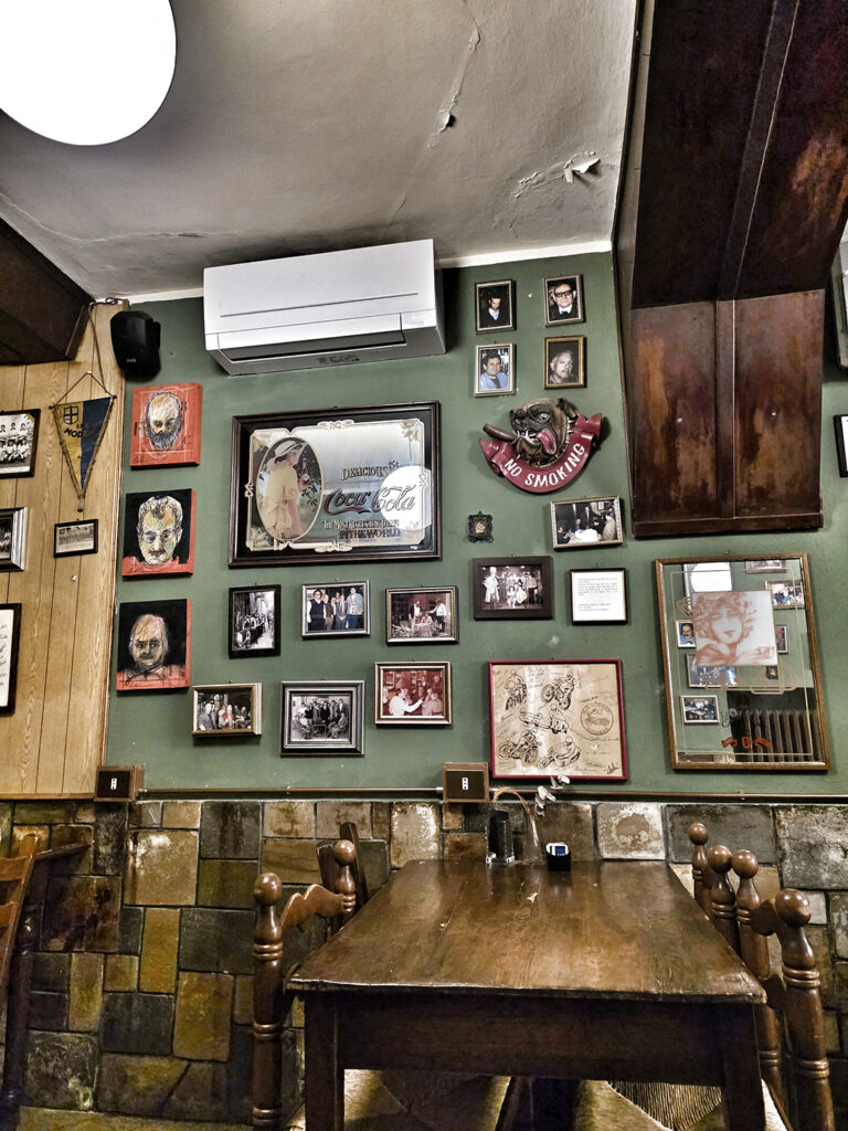 Modena "bar" with framed photos of art and previous owners and family members adorn the walls