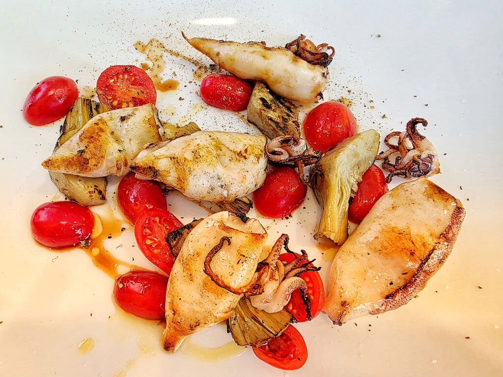 Squid, artichoke, and tomato drizzled with balsamic vinegar